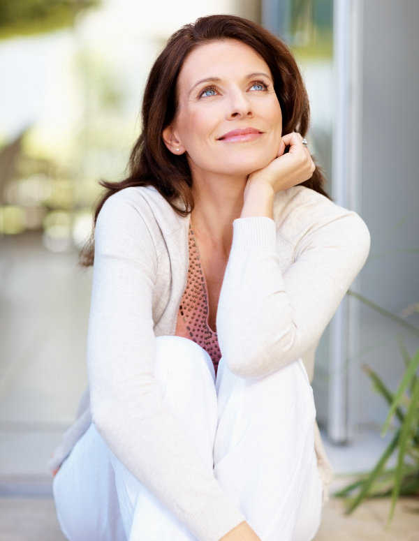 Mature woman looking away day dreaming